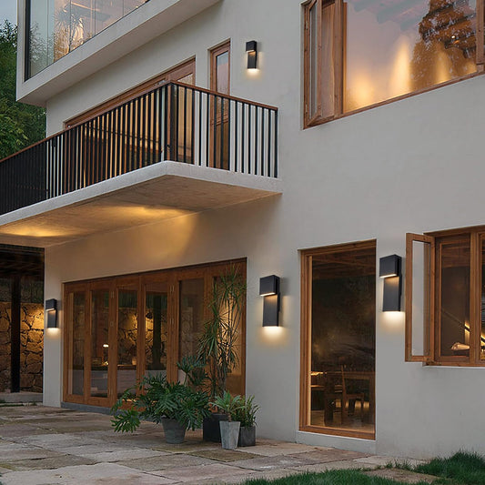 Modern house exterior with balconies, windows, and outdoor lighting.