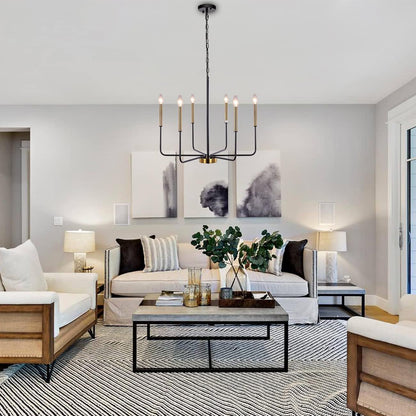 Modern living room with a chandelier, sofa, coffee table, and decorative elements.