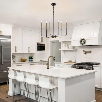 Modern kitchen with white island, bar stools, and stainless steel appliances.