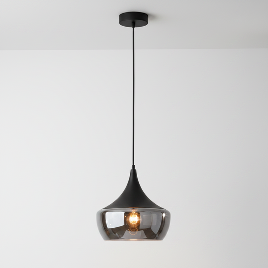 A modern teardrop-shaped pendant light with a glossy black metal frame, a clear smoked glass shade, and a visible warm Edison bulb, suspended against a plain white background.