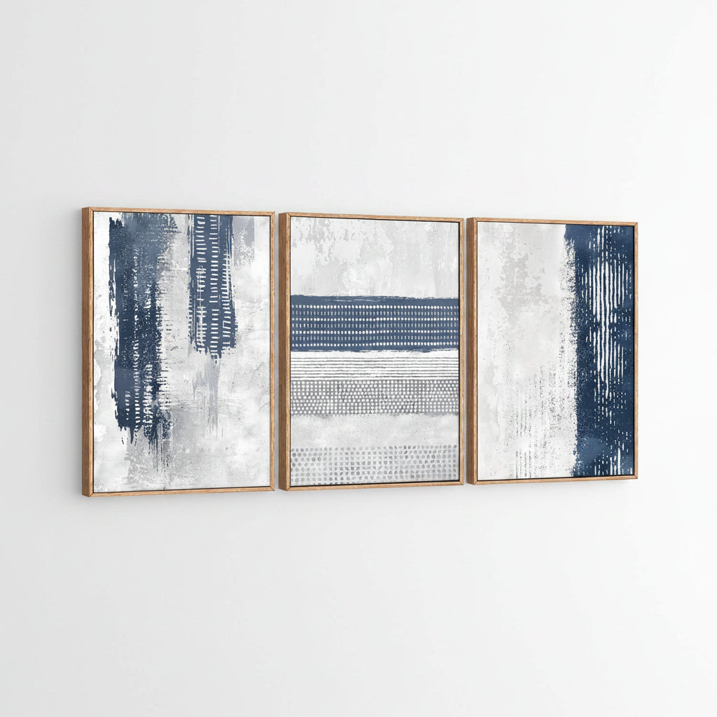 Three abstract art pieces with blue and white patterns in wooden frames.