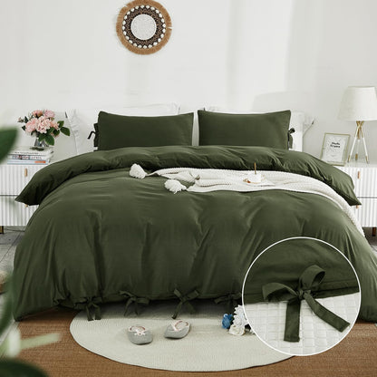 Green bedspread set on a bed in a bedroom with decorative elements.