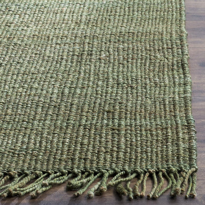 Green textured rug with tassels on a wooden floor