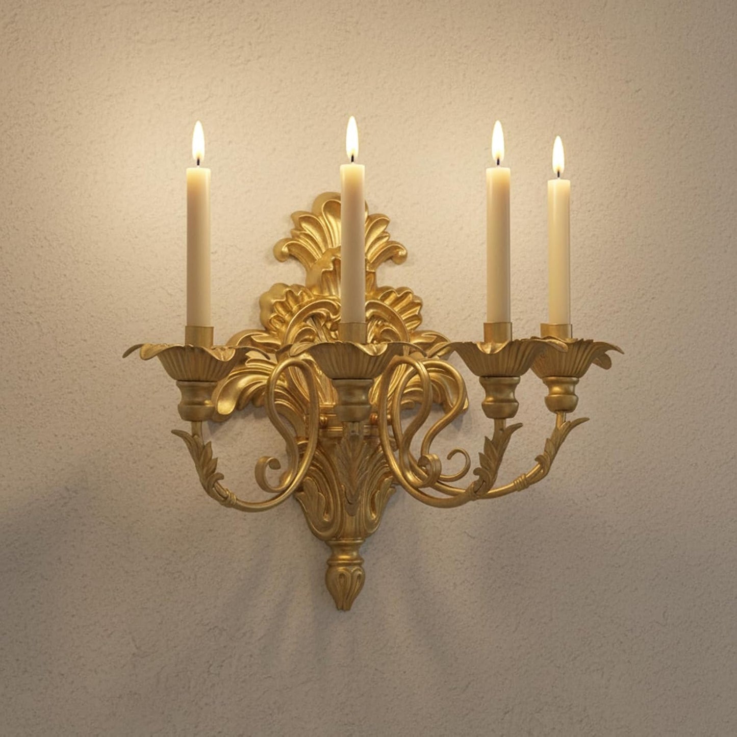 Gold wall sconce with four lit candles on a beige wall.