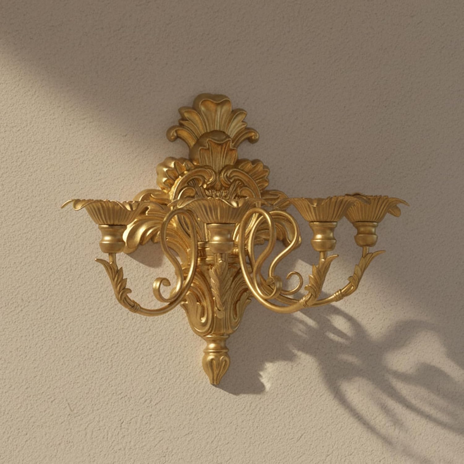 Decorative gold wall sconce on a beige wall
