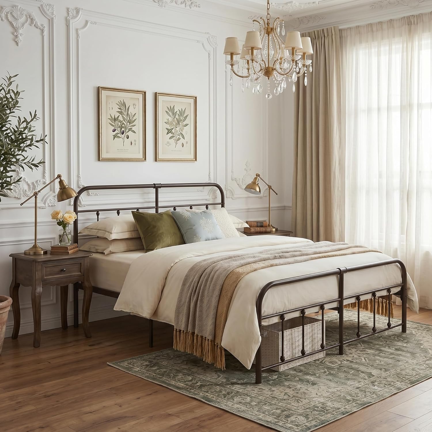 A dark metal bed frame with a classic guardrail design, styled in a bright, traditional bedroom with beige bedding, decorative pillows, bedside tables, and a chandelier.