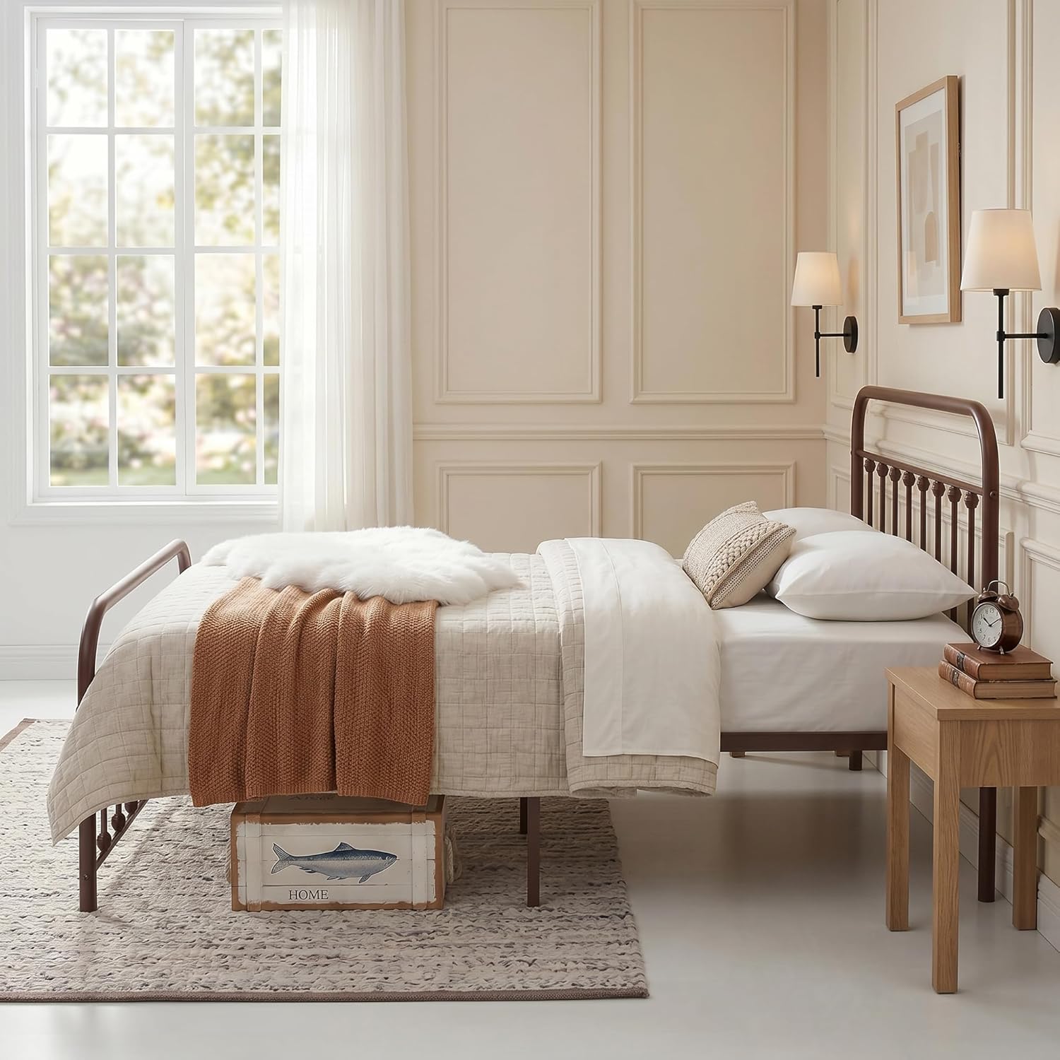 A twin-size metal bed frame with a dark brown spindle headboard and footboard, styled with white bedding, a rust-orange throw blanket, and a white faux fur pillow in a bright, classic bedroom.