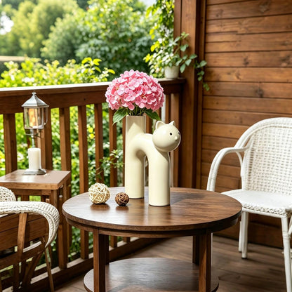 Outdoor setting with a wooden table, chairs, and decorative items on a deck.