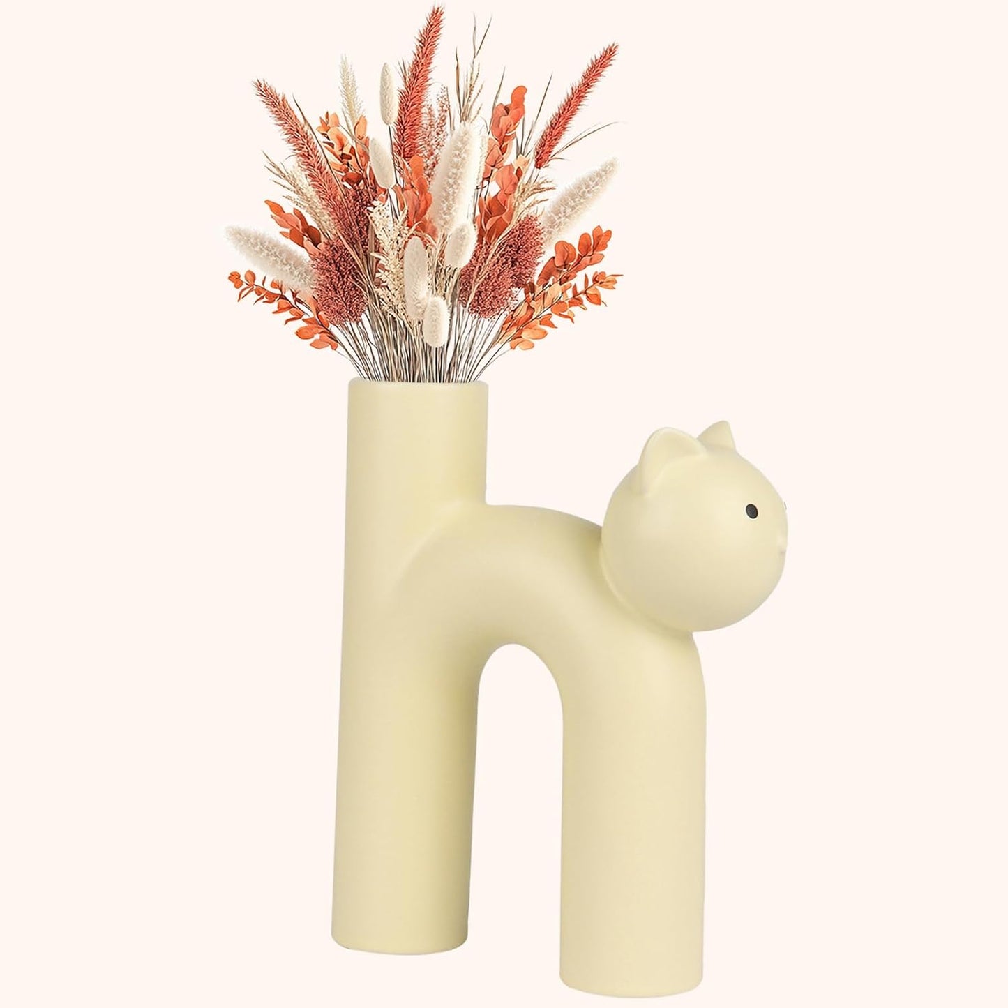 Cat-shaped vase with dried flowers on a white background