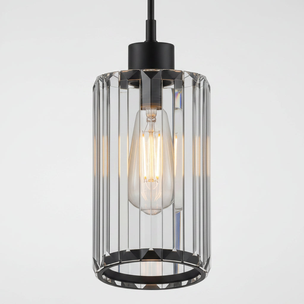 A modern industrial pendant light with a black metal canopy and base, featuring a clear glass cylindrical cage with vertical fluted bars and a glowing warm Edison bulb inside.