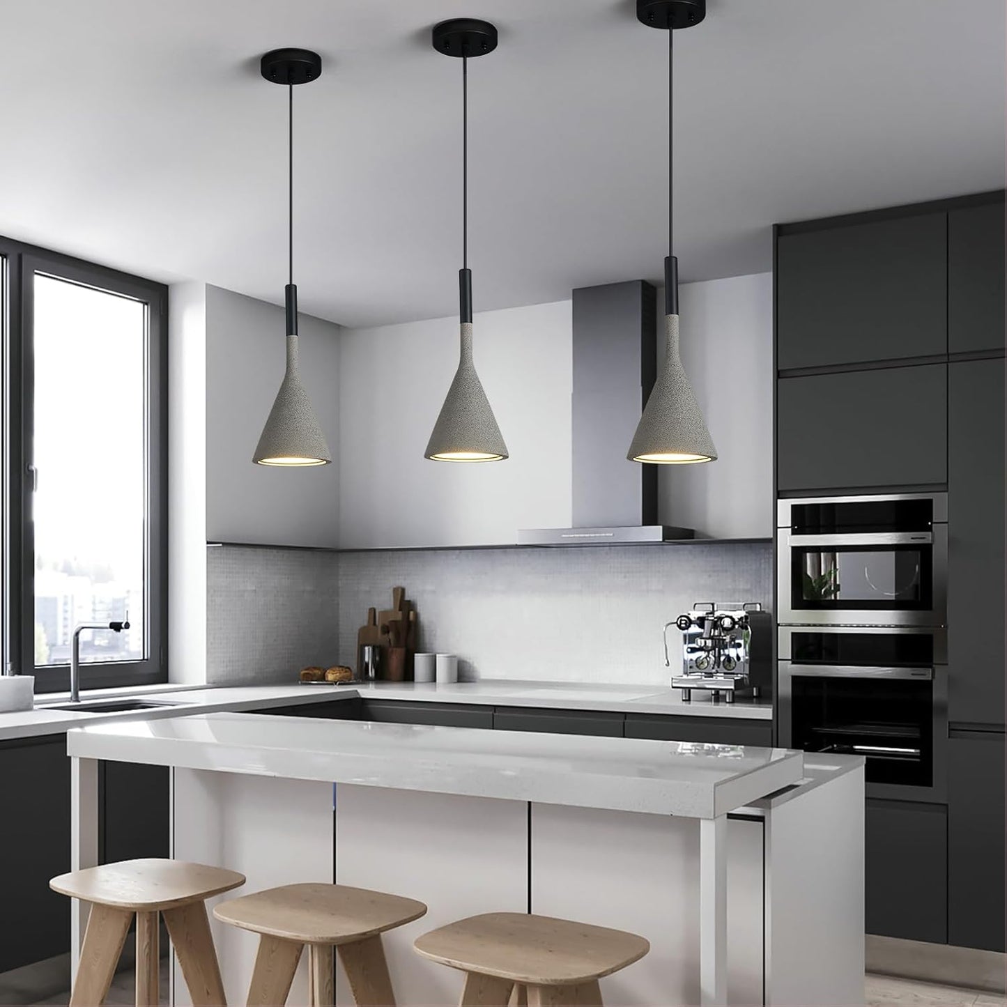Modern kitchen with white island, black appliances, and pendant lights.