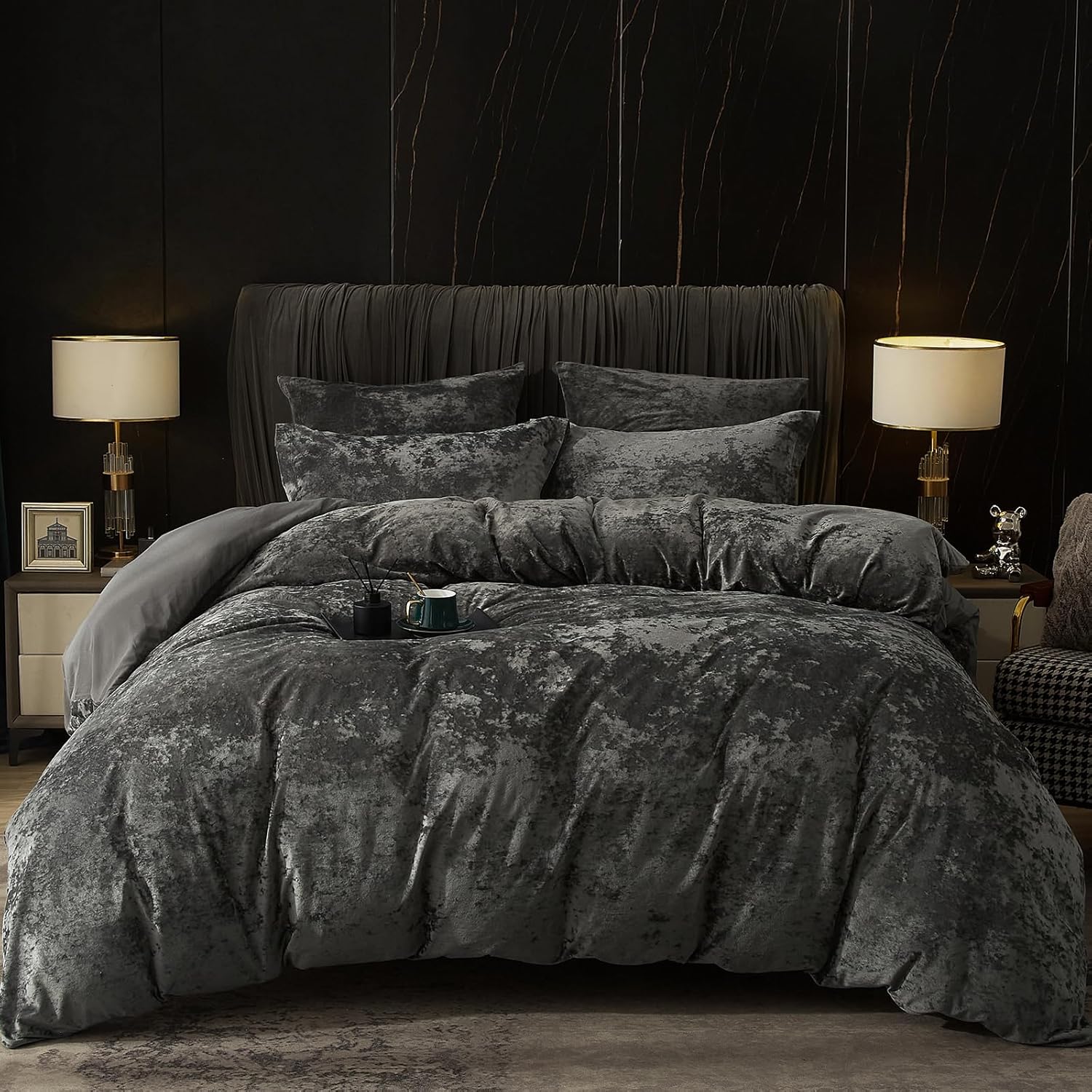 Dark gray textured bedding set on a bed in a dimly lit bedroom.