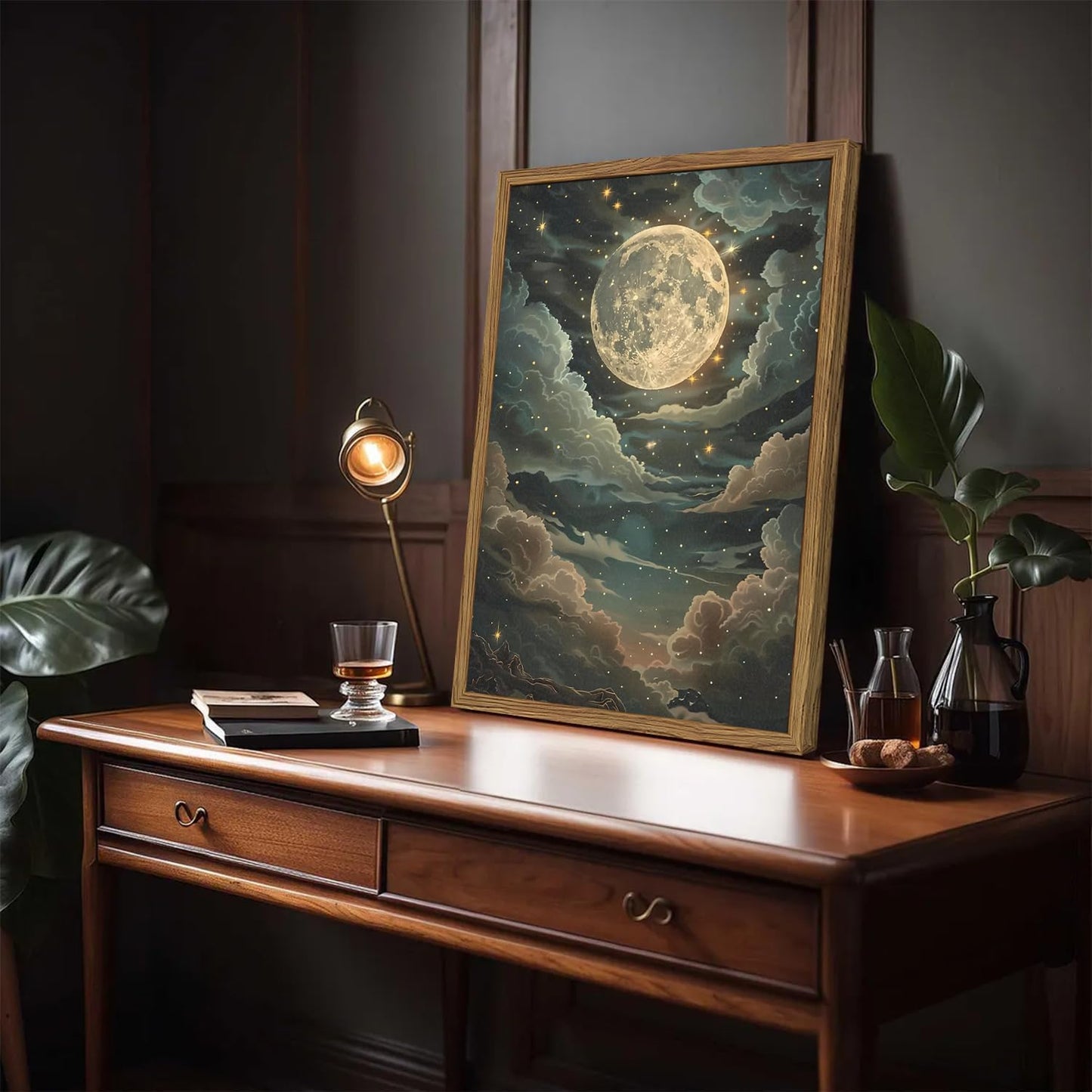 Framed artwork of a celestial scene on a wooden desk with a lamp and books.