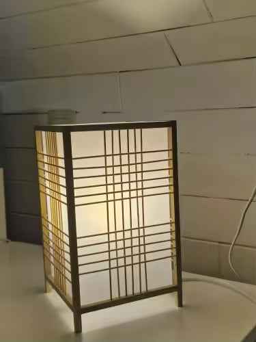 Decorative lamp with grid pattern on a neutral background