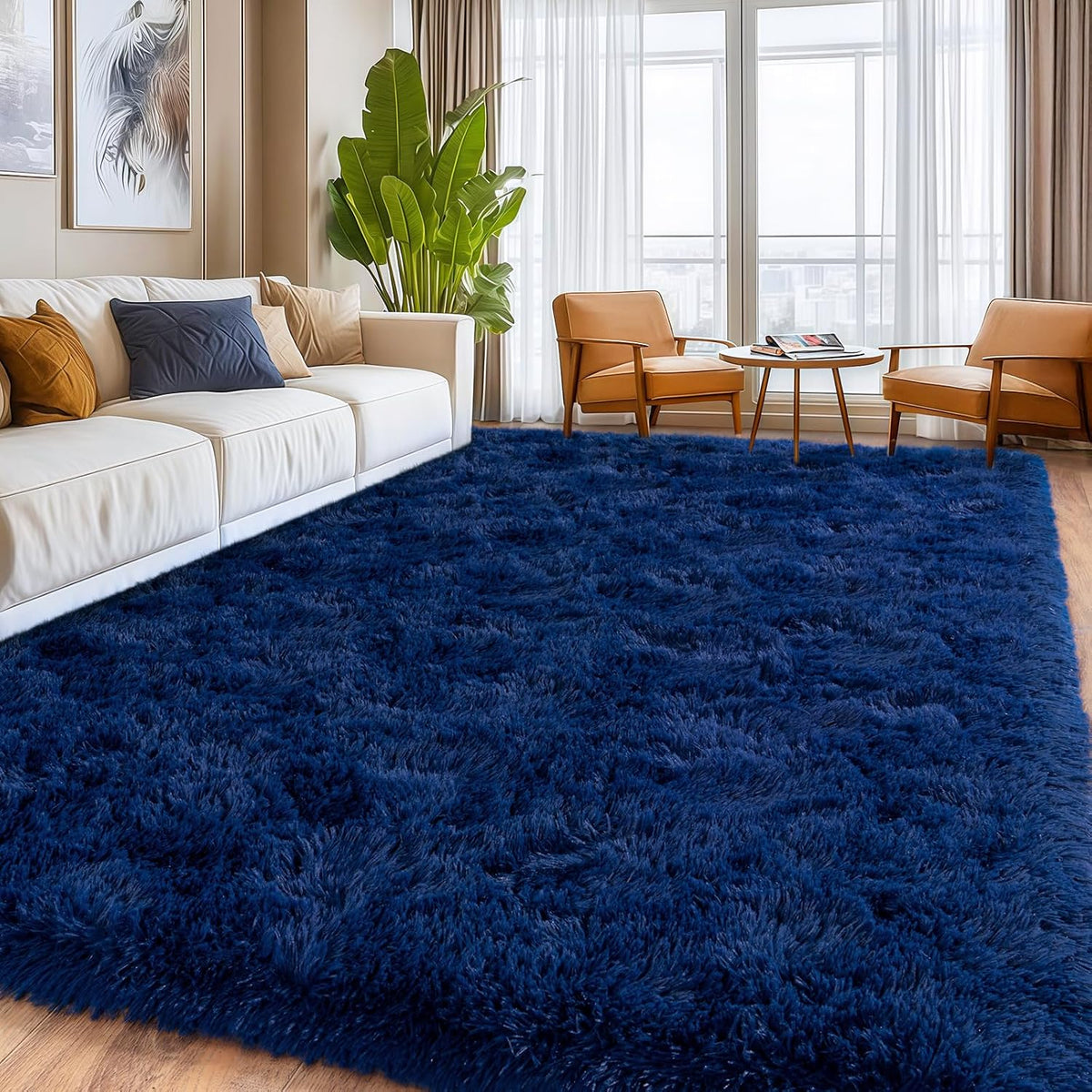 A large, deep navy blue shag area rug covering the floor in a modern living room setting with a white sofa, two orange armchairs, and a potted plant.
