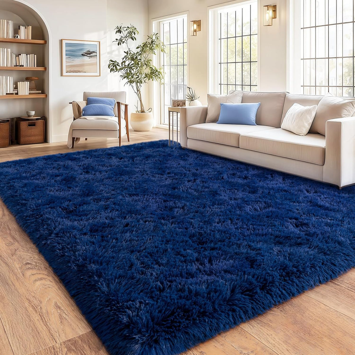 Blue shaggy rug in a living room with a beige sofa and wooden floor.