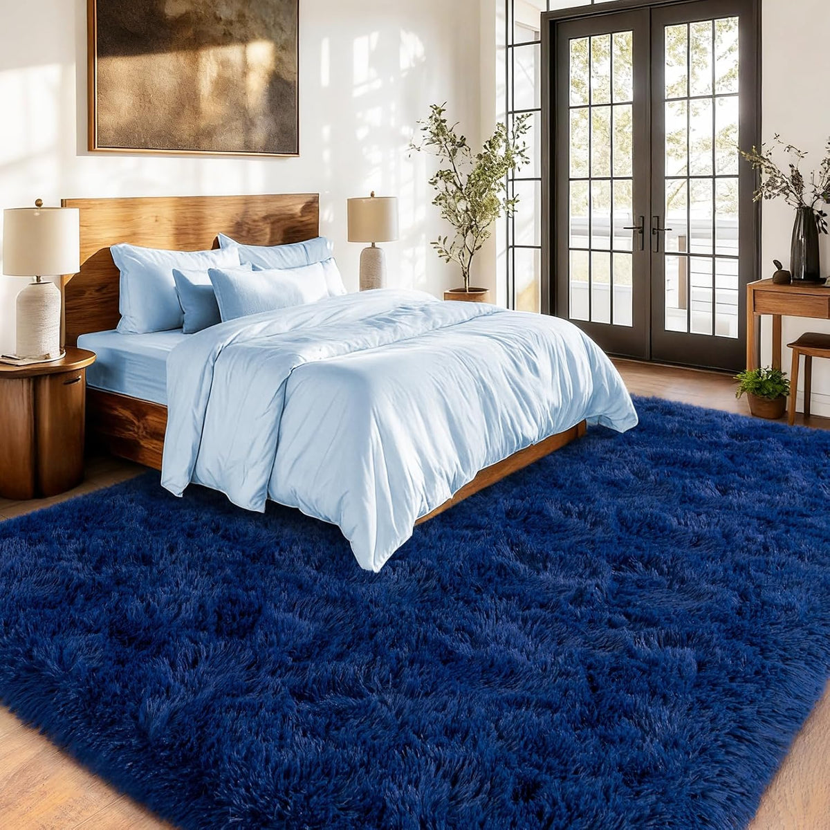 Bedroom with a blue rug, wooden bed, and side tables.