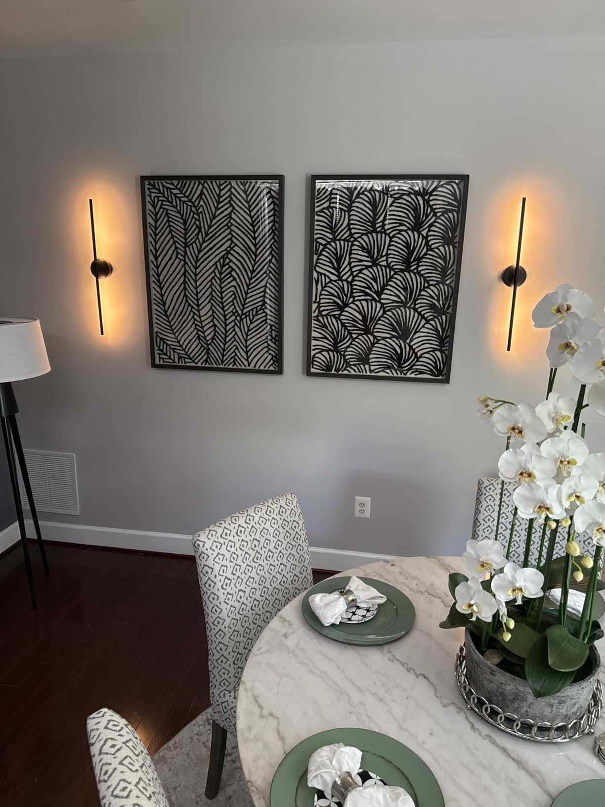 Dining room with round table, chairs, and wall art