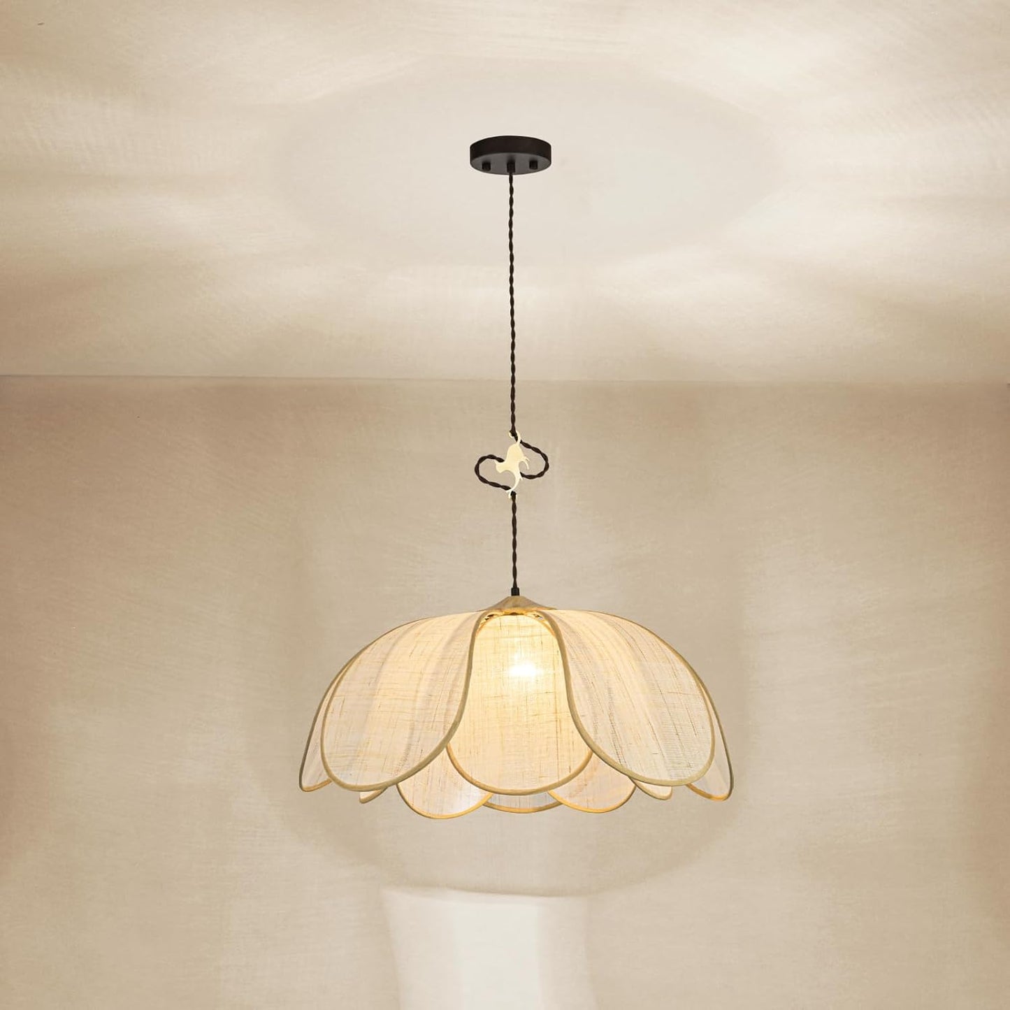 Decorative pendant light with floral design on a neutral background