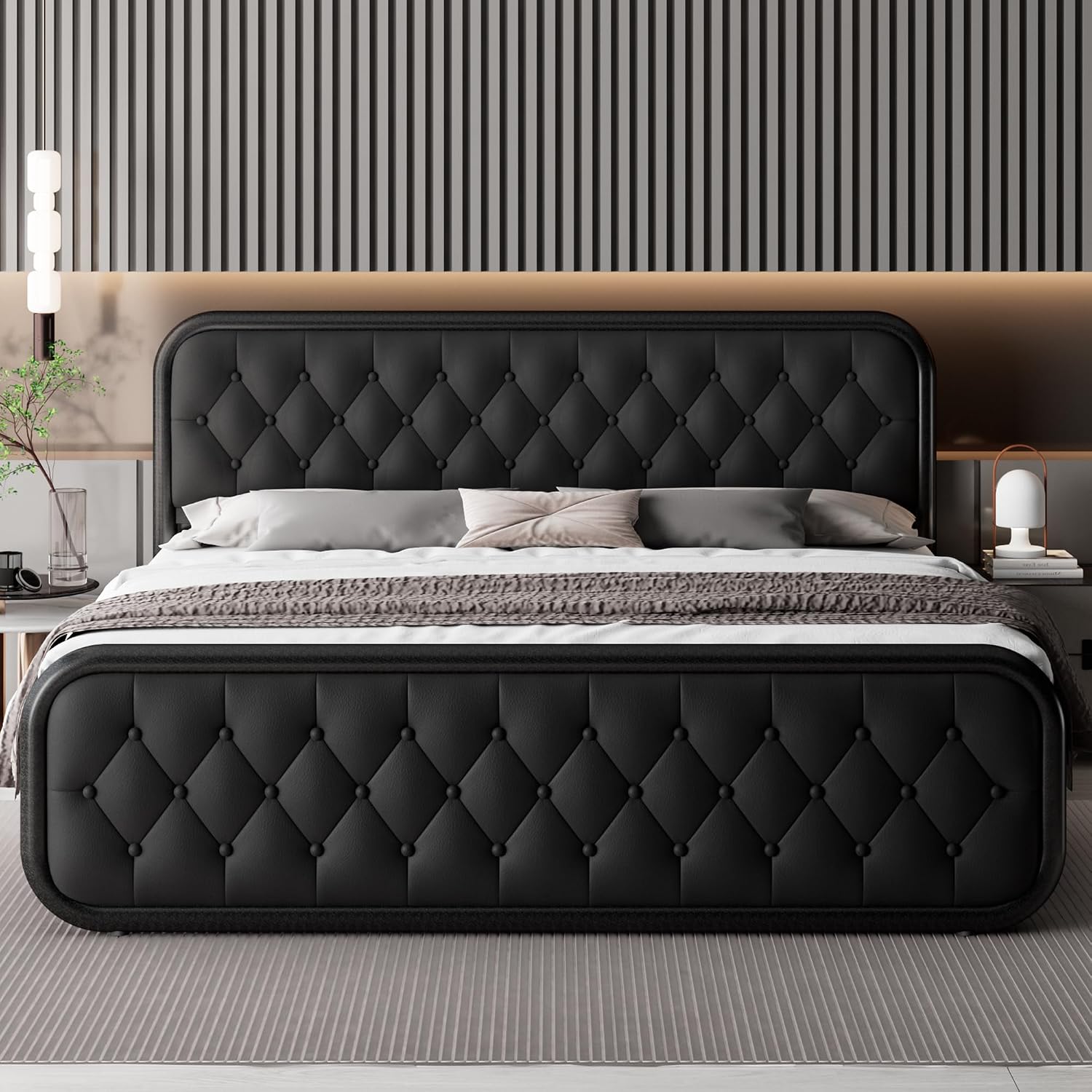 A modern black tufted upholstered bed with a tall matching headboard and footboard, styled in a contemporary bedroom with striped wall panels, neutral bedding, and bedside tables.