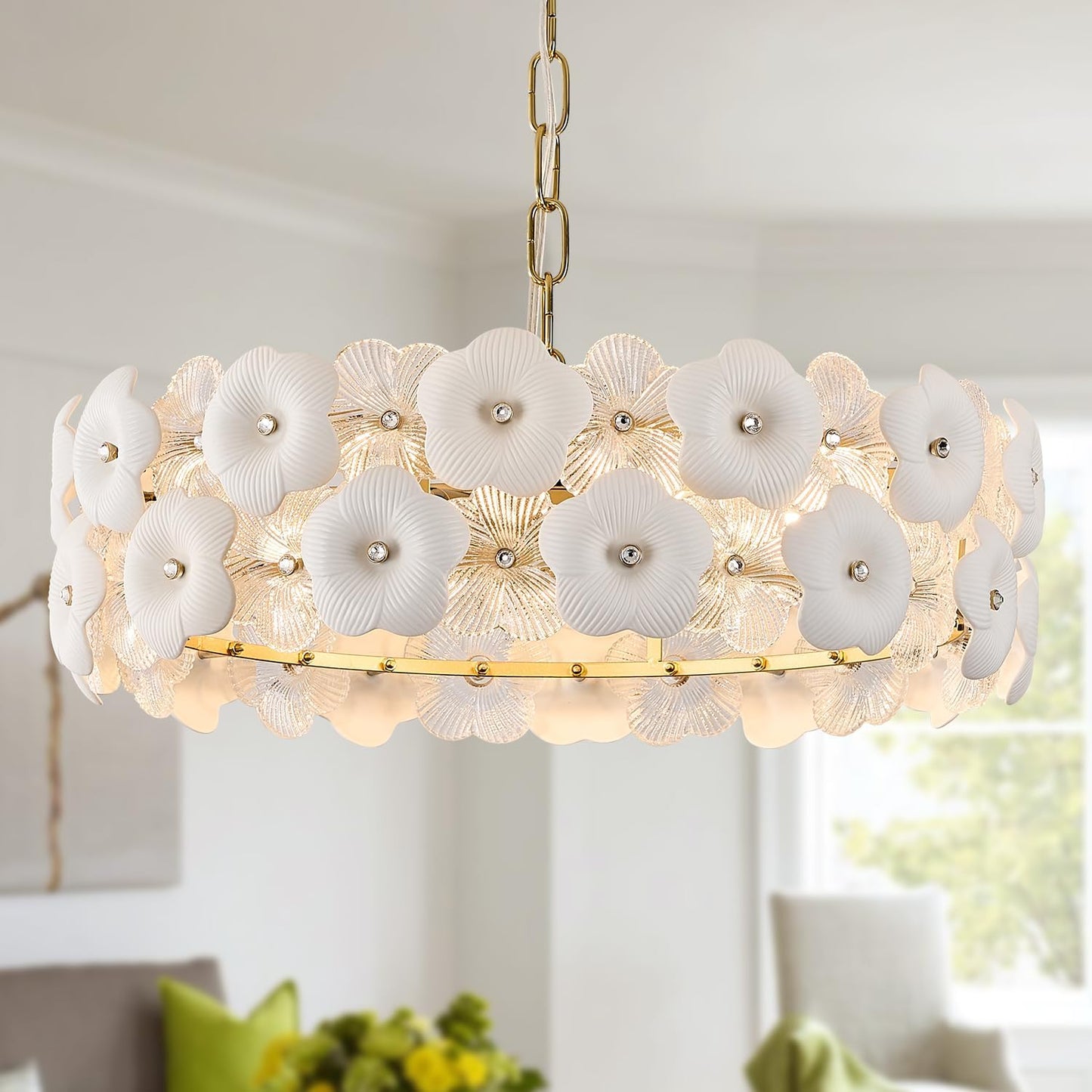 Floral chandelier with white flowers and gold accents in a room setting.
