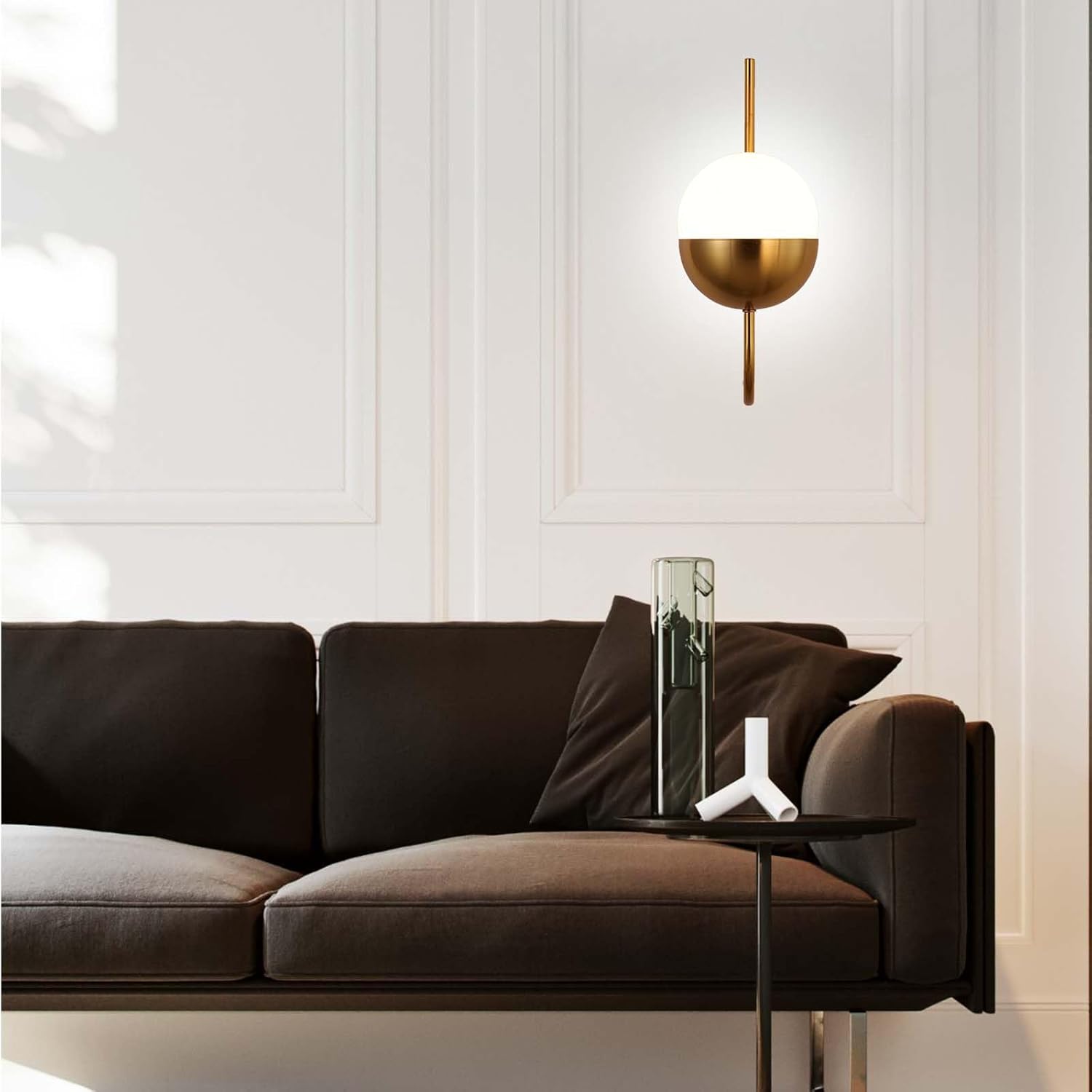 Modern living room with a brown sofa, small round table, and decorative lamp.