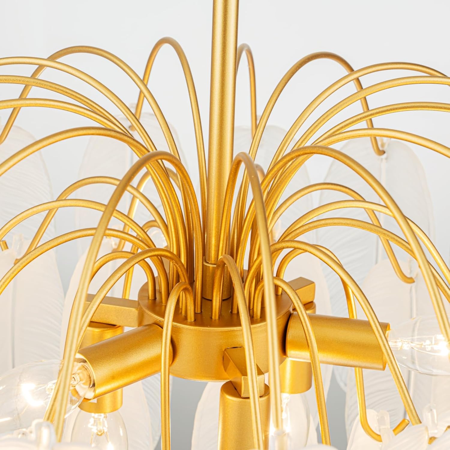 Gold chandelier with intricate design on a white background