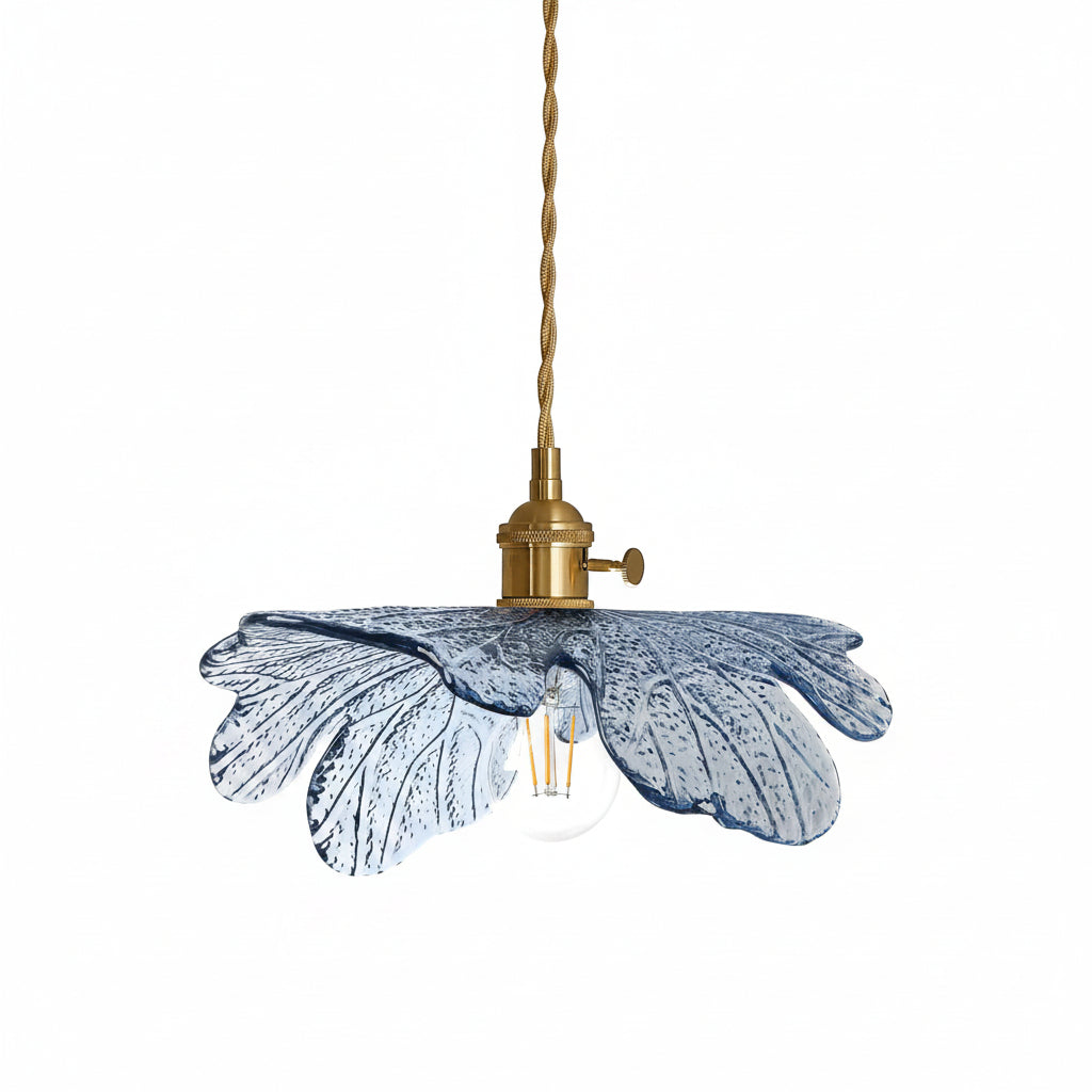 Pendant light with blue glass shade and brass fixture on a white background