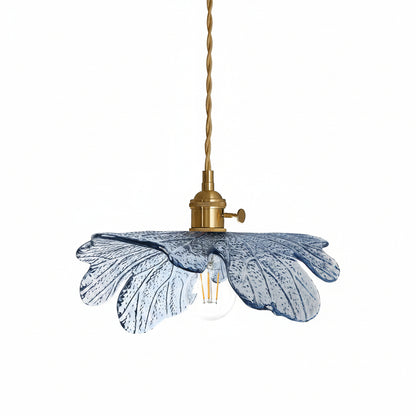 Pendant light with blue glass shade and brass fixture on a white background