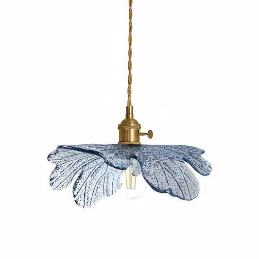 Pendant light with blue glass shade and brass fixture on a white background