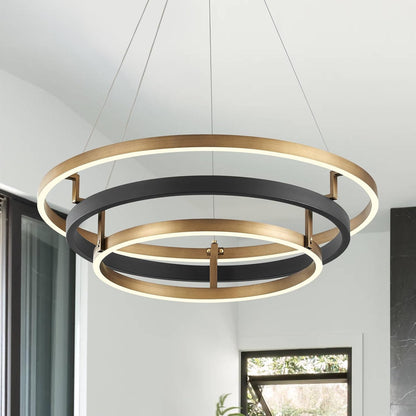 Modern pendant light with gold and black rings in a room setting
