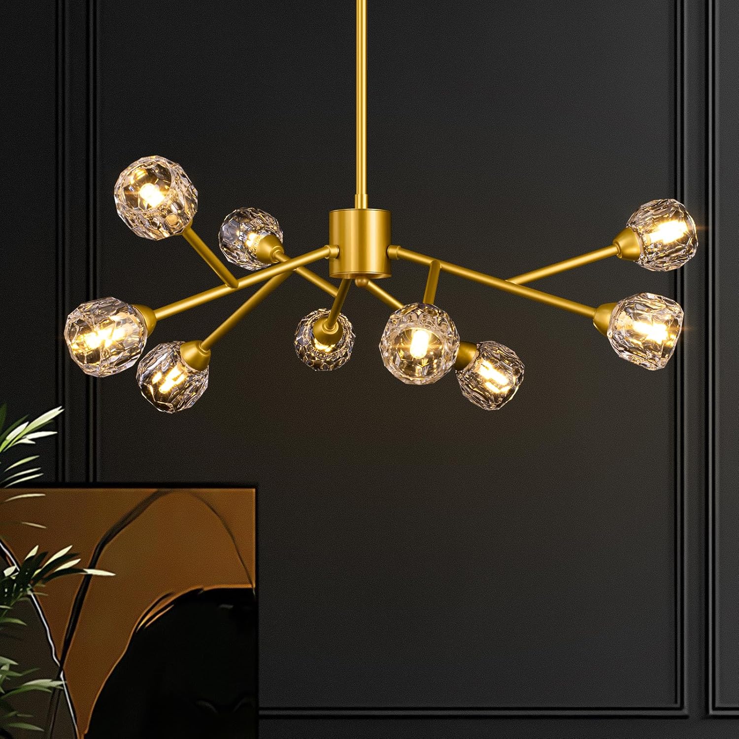 Gold chandelier with crystal-like glass shades against a dark background