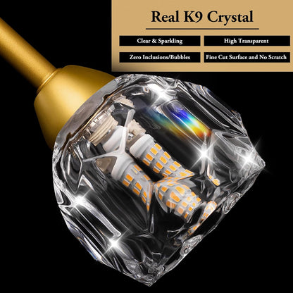 Diamond-shaped LED light bulb with gold base on a black background, featuring text about K9 crystal quality.