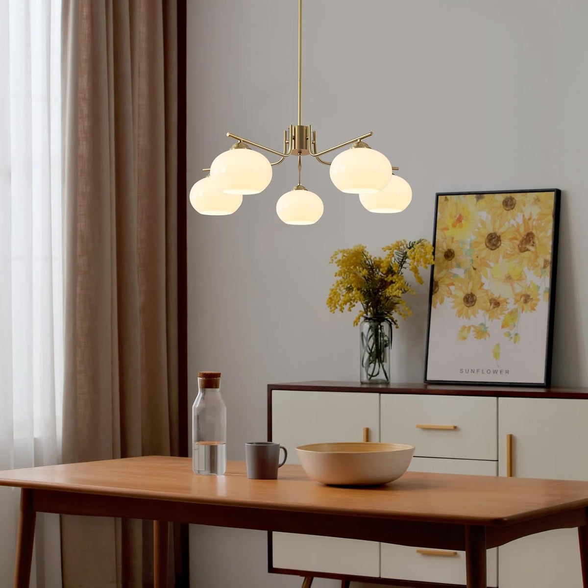 Modern dining room with a pendant light fixture, table, and decorative elements.