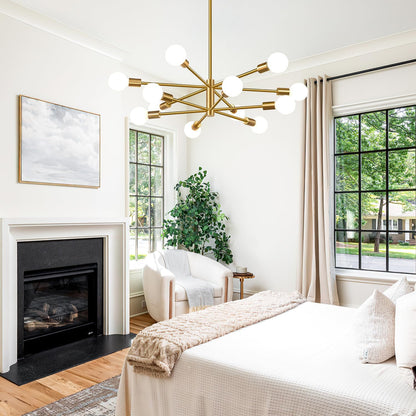 Modern bedroom with a gold chandelier, fireplace, and large windows.