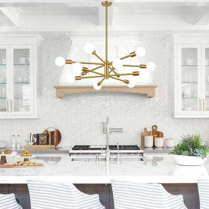 Modern kitchen with a gold chandelier, white marble countertops, and stainless steel appliances.