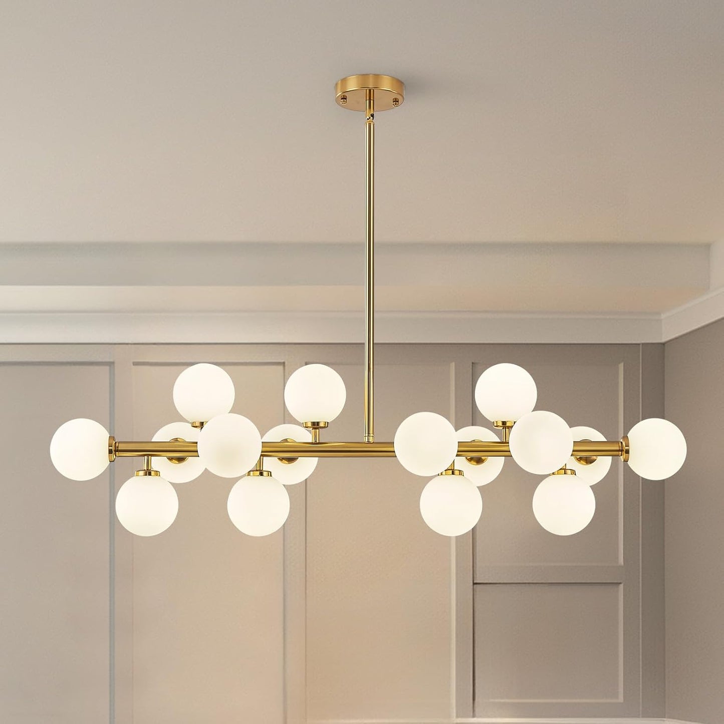 Modern chandelier with gold fixtures and white glass shades in a room setting.