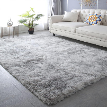 Gray shaggy rug in a living room with a white sofa and decorative elements.