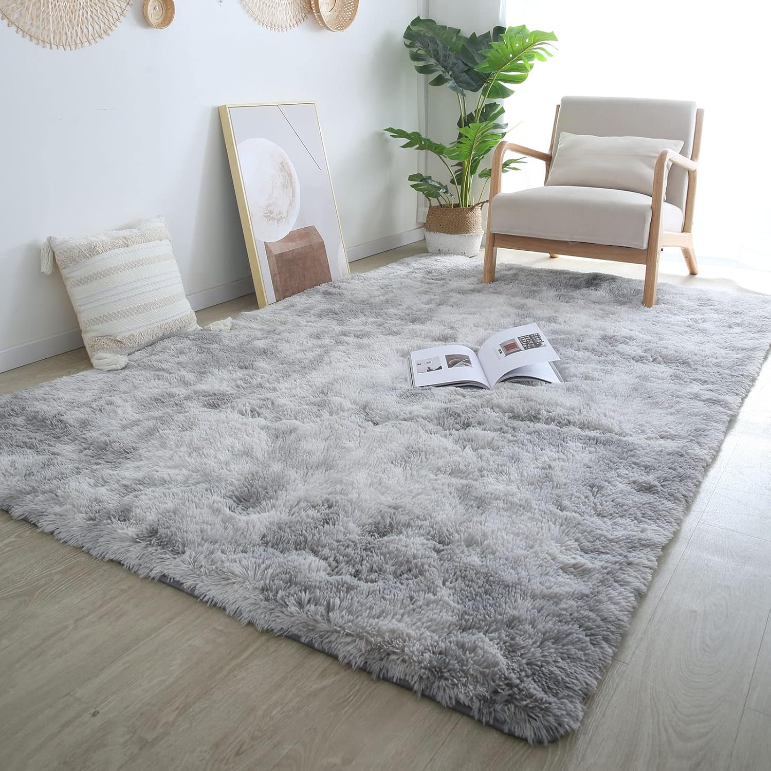 Gray shaggy rug in a room with a chair, plant, and picture frame.