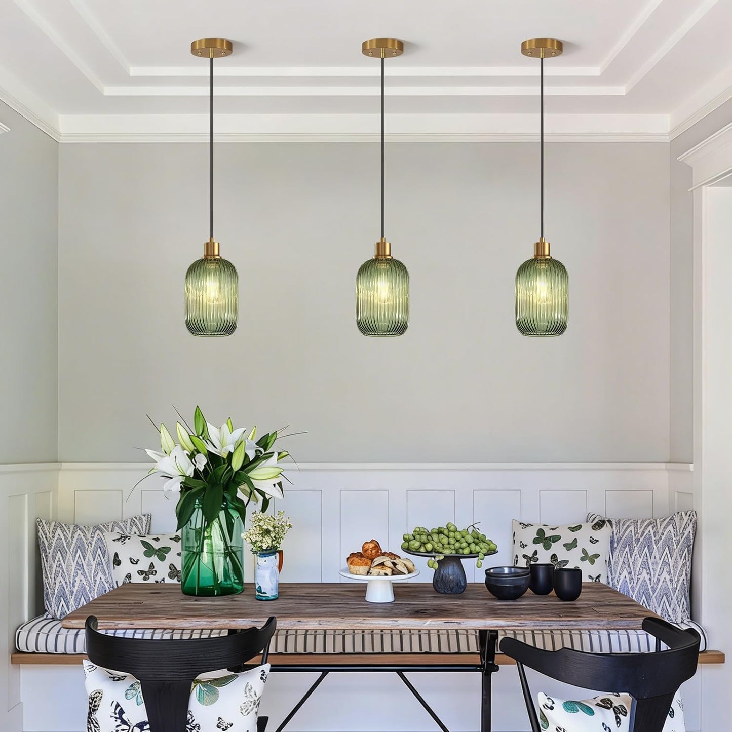 Dining room with wooden table, chairs, and pendant lights.