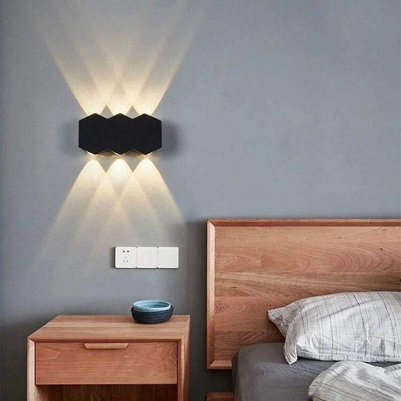 The Trilight Glow LED Wall Sconce illuminates the outdoor wall with three lights.
