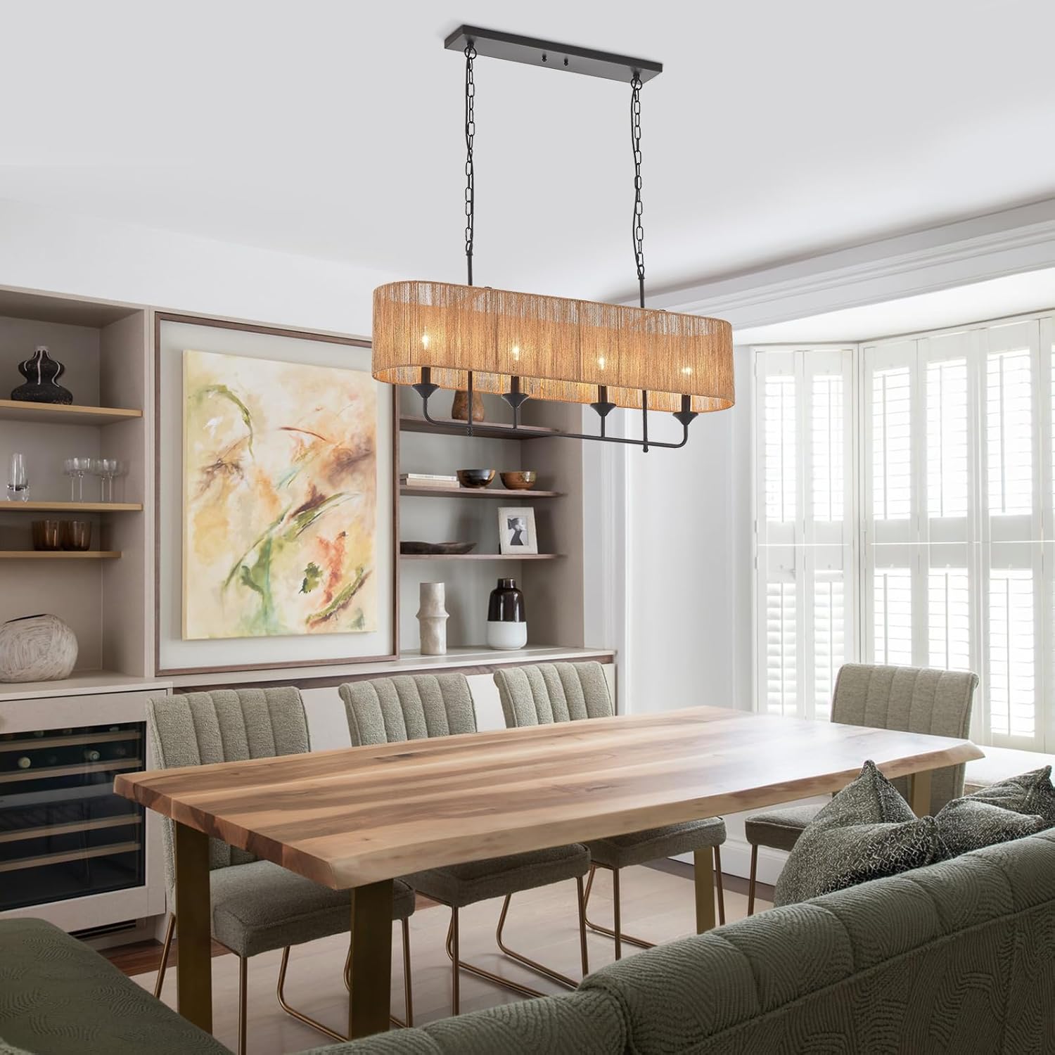 Dining room with wooden table, chairs, and a pendant light fixture.