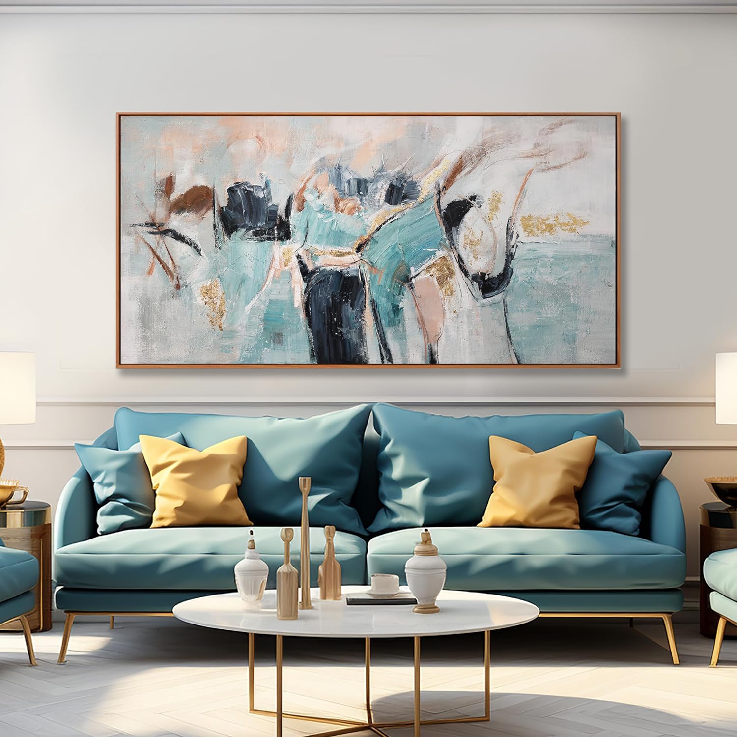 A large framed abstract canvas print with teal, cream, black, and gold brushstrokes hangs on a light gray wall above a teal sofa with yellow accent pillows in a modern living room setting.