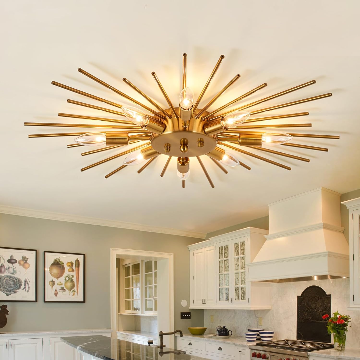 Gold ceiling light fixture in a kitchen with white cabinets and decorative elements.