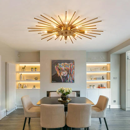 Modern dining room with a gold ceiling light fixture, table, and chairs.