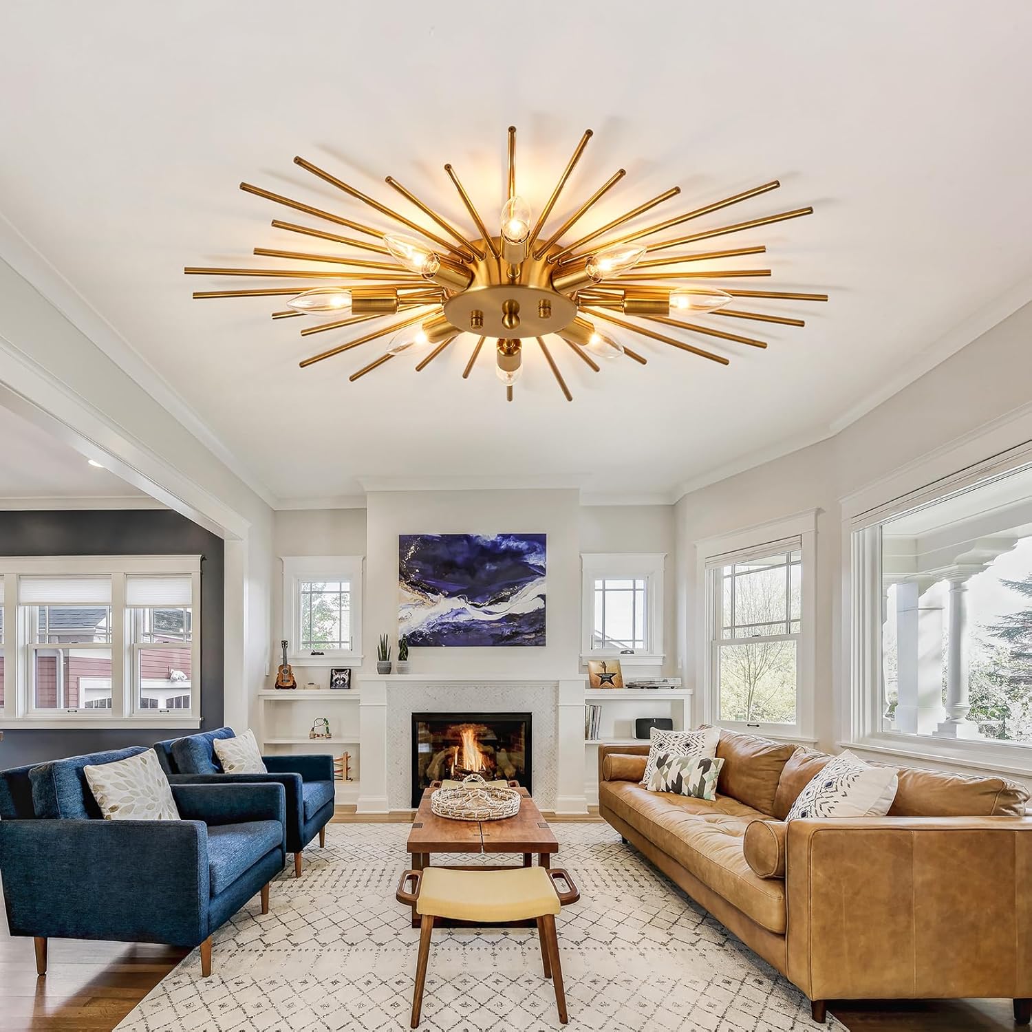 Living room with a gold ceiling light fixture, brown sofa, blue armchair, and fireplace.