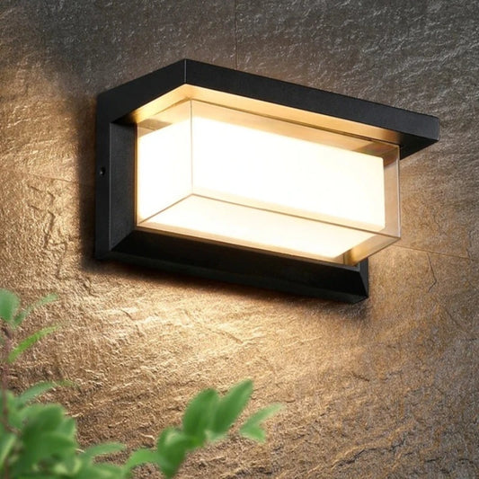 Outdoor LED light with motion sensor for porch, emitting a soft glow to illuminate the surroundings.
