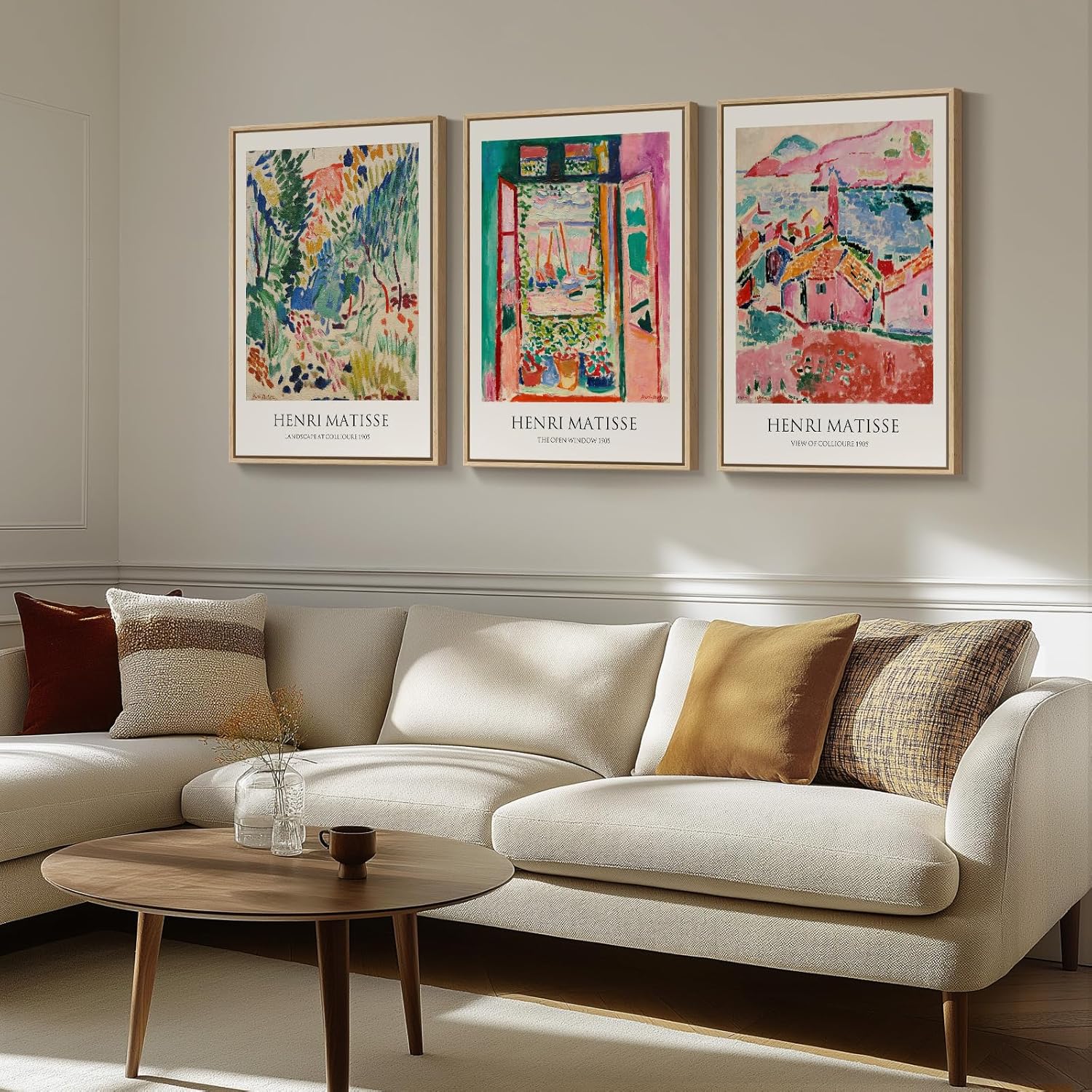Living room with a beige sectional sofa, wooden coffee table, and three framed Henri Matisse artworks on the wall.