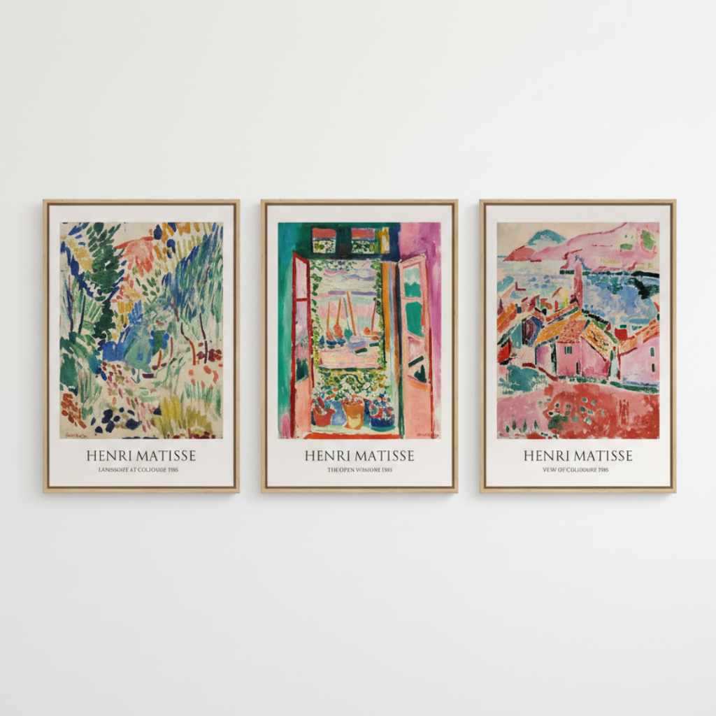 Three framed Henri Matisse art prints hanging side-by-side on a white wall. Each print features a colorful, textured painting of a different scene (garden, doorway, and houses) with 'HENRI MATISSE' printed in black at the bottom.