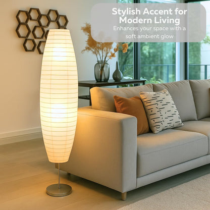 Floor lamp in a living room setting with a couch and decorative elements.